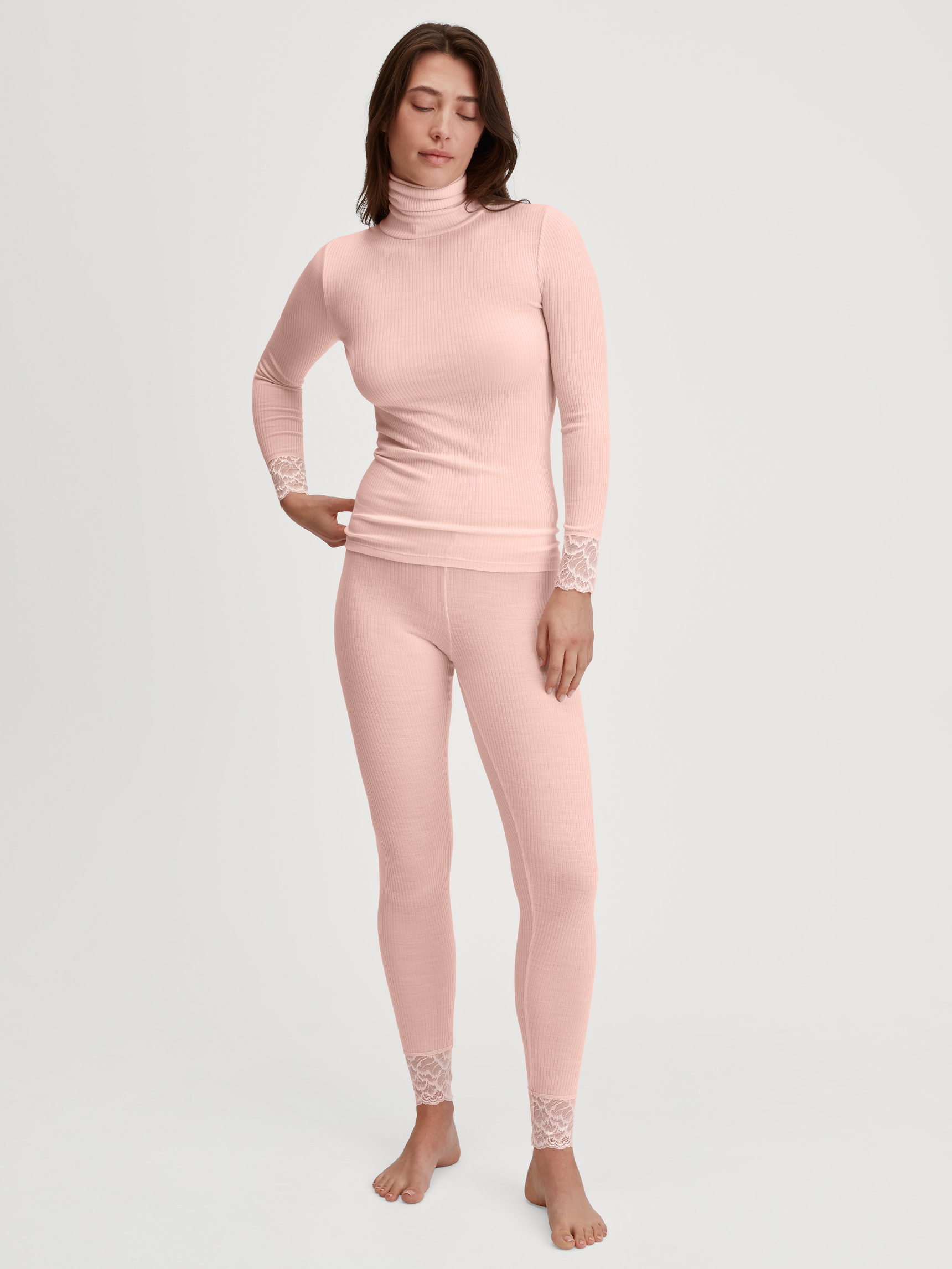 La modella / Il modello Donna indossa Maglia a maniche lunghe dolcevita in lana-seta in Lana di colore Rosa, Pizzo, della serie Silky Wool Joy di CALIDA, Abbigliamento