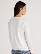 Women model is wearing Long-sleeve shirt with raglan sleeves made of 100% Cotton in White, Unicoloured from the Favourites Sleep series by CALIDA, Back view