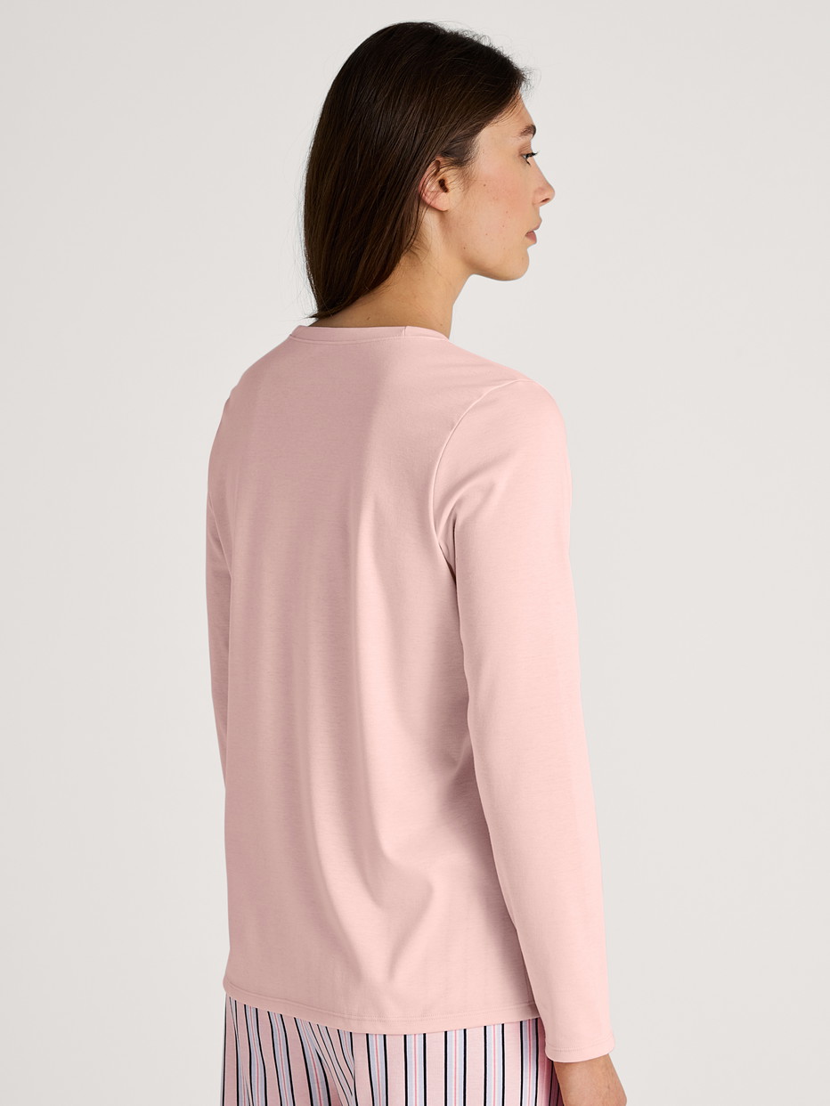 Women model is wearing Shirt long sleeve made of 100% Cotton in Pink, Unicoloured from the Favourites Sleep series by CALIDA, Back view