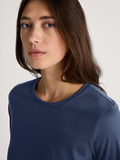 Women model is wearing Shirt long sleeve made of 100% Cotton in Blue, Floral from the Favourites Sleep series by CALIDA, Detail