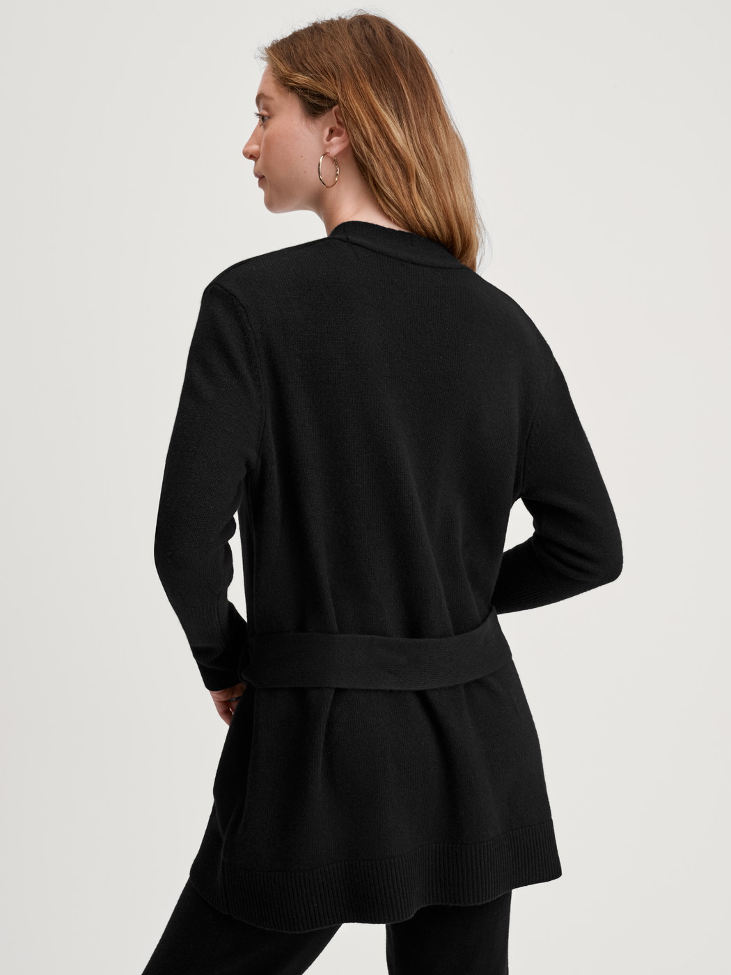 Women model is wearing Cardigan made of merino wool made of Wool in Black, Unicoloured from the The Cosy Collection series by CALIDA, Back view