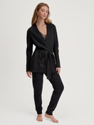 Women model is wearing Cardigan made of merino wool made of Wool in Black, Unicoloured from the The Cosy Collection series by CALIDA, Outfit