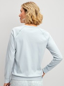 Women model is wearing Long-sleeve shirt made of 100% Cotton in Blue, Unicoloured from the Alpine M&M series by CALIDA, Back view