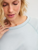 Women model is wearing Long-sleeve shirt made of 100% Cotton in Blue, Unicoloured from the Alpine M&M series by CALIDA, Detail