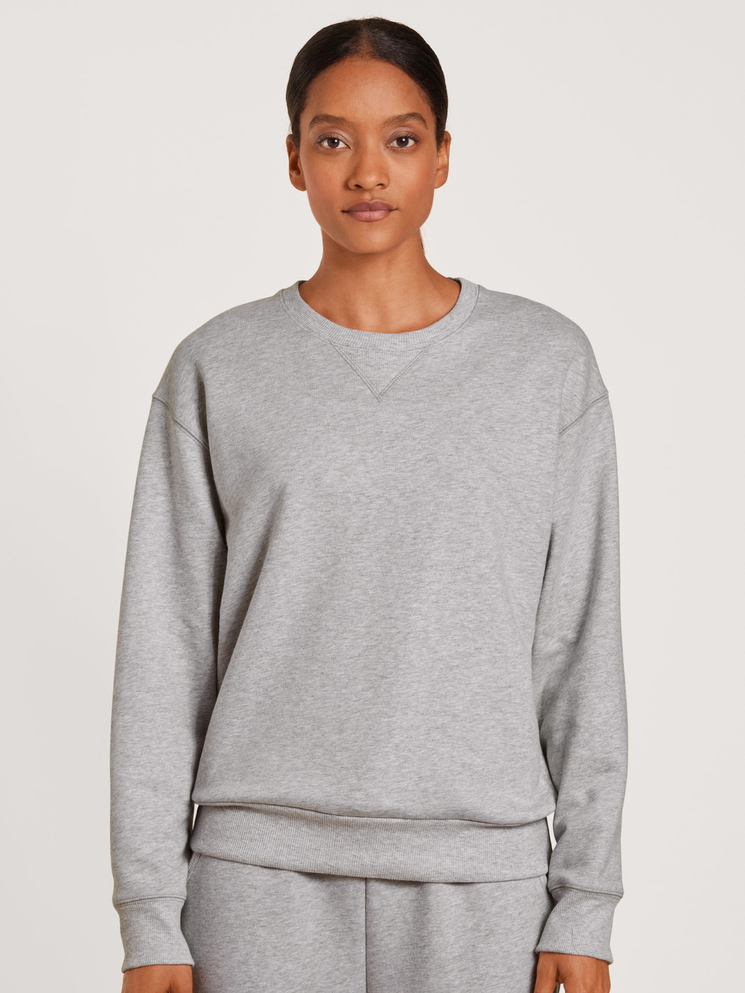 Women model is wearing Sweatshirt made of 100% Cotton in Grey, Unicoloured from the Circular Lounge series by CALIDA, Front view