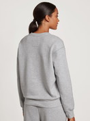 Women model is wearing Sweatshirt made of 100% Cotton in Grey, Unicoloured from the Circular Lounge series by CALIDA, Back view