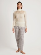Women model is wearing Long-sleeve turtleneck shirt in wool-silk made of Wool in Beige, Lace from the Silky Wool Glam series by CALIDA, Outfit