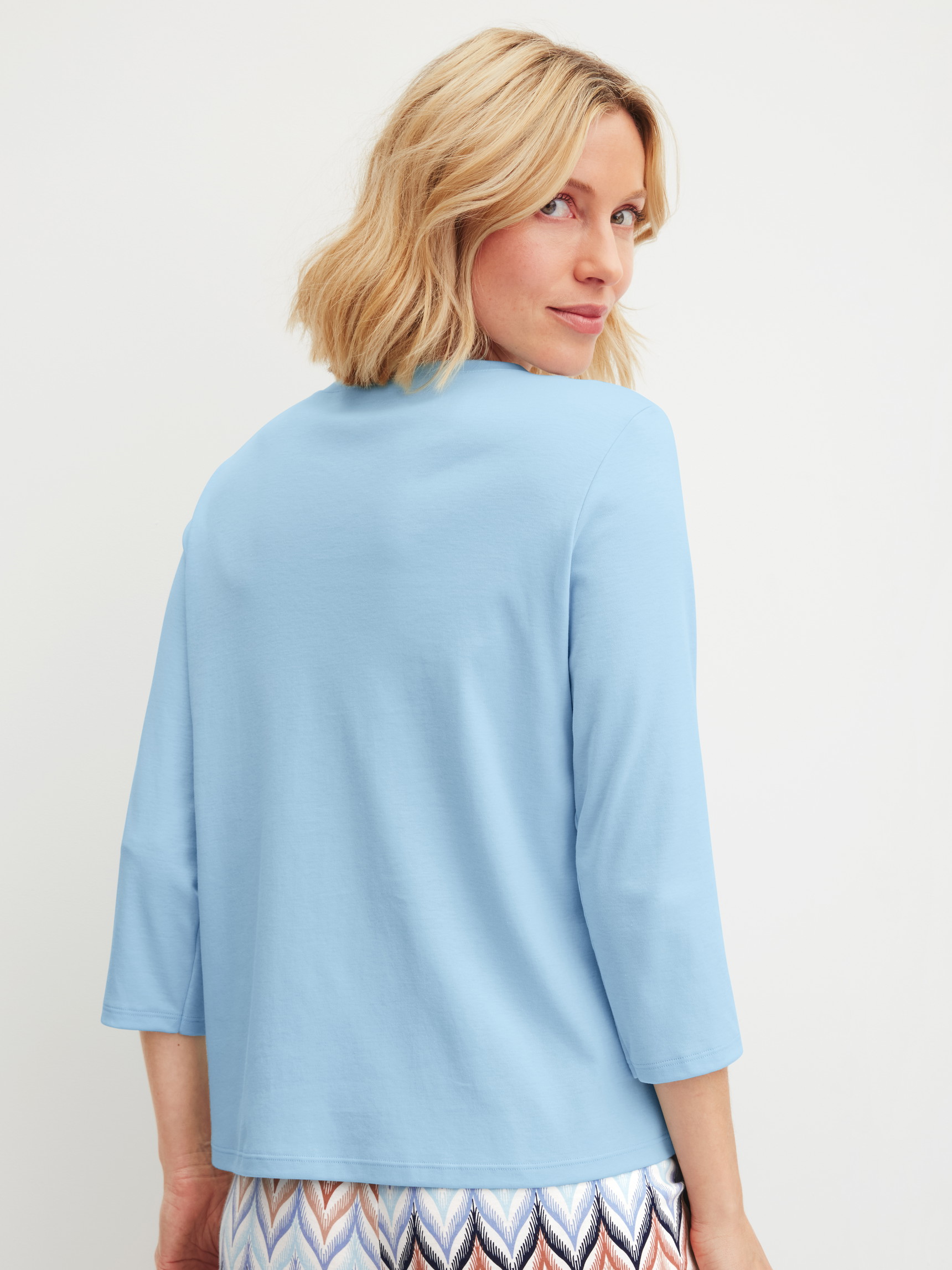 Women model is wearing Shirt 3/4 sleeve made of 100% Cotton in Blue, Unicoloured from the Favourites Tiles series by CALIDA, Back view