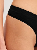 Women model is wearing String made of Modal in Black, Unicoloured from the Seamless Natural series by CALIDA, Detail