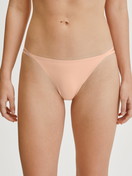 Women model is wearing Low Cut Tanga Brief made of Polyamide in Beige, Unicoloured from the Sleek Skin series by CALIDA, Front view