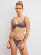 Women model is wearing Low Cut Tanga Brief made of Polyamide in Brown, Unicoloured from the Sleek Skin series by CALIDA, Outfit