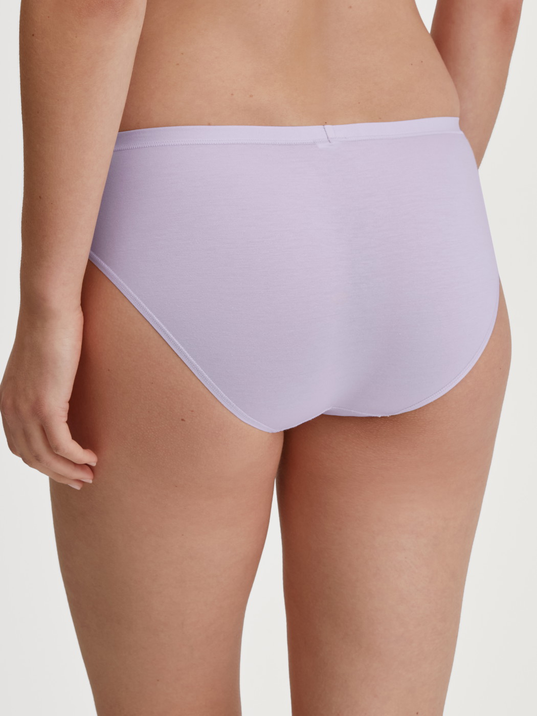 Women model is wearing Brief, regular cut made of Cotton in Purple, Unicoloured from the Natural Comfort series by CALIDA, Back view