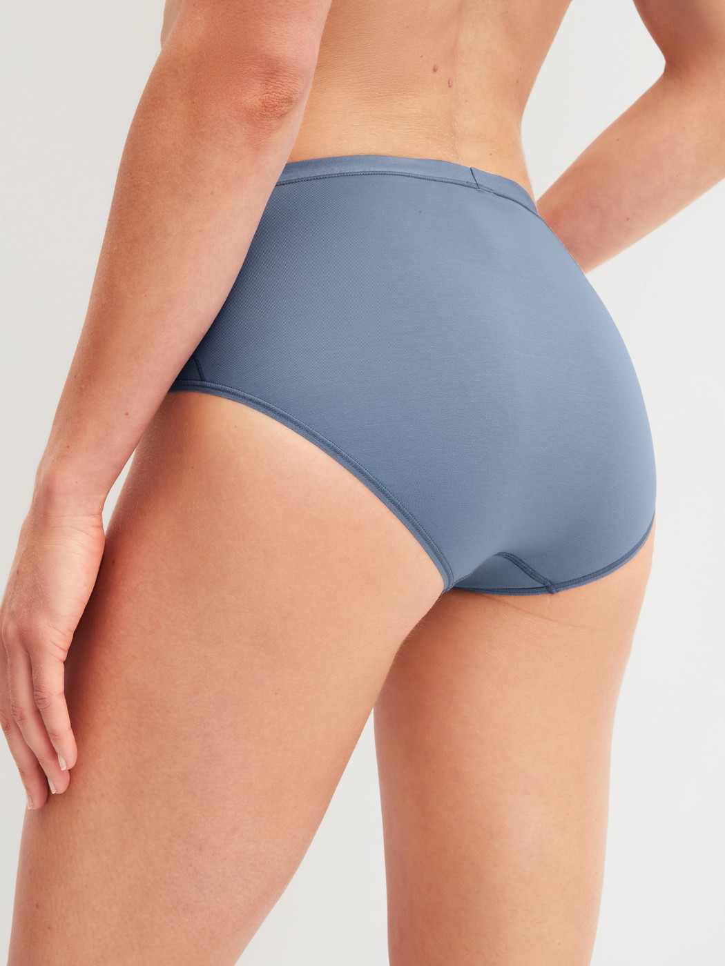 Women model is wearing Brief made of Cotton in Blue, Unicoloured from the Natural Comfort series by CALIDA, Back view