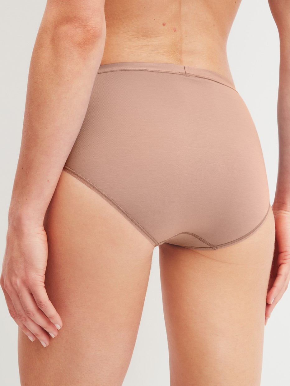 Women model is wearing Brief made of Cotton in Brown, Unicoloured from the Natural Comfort series by CALIDA, Back view