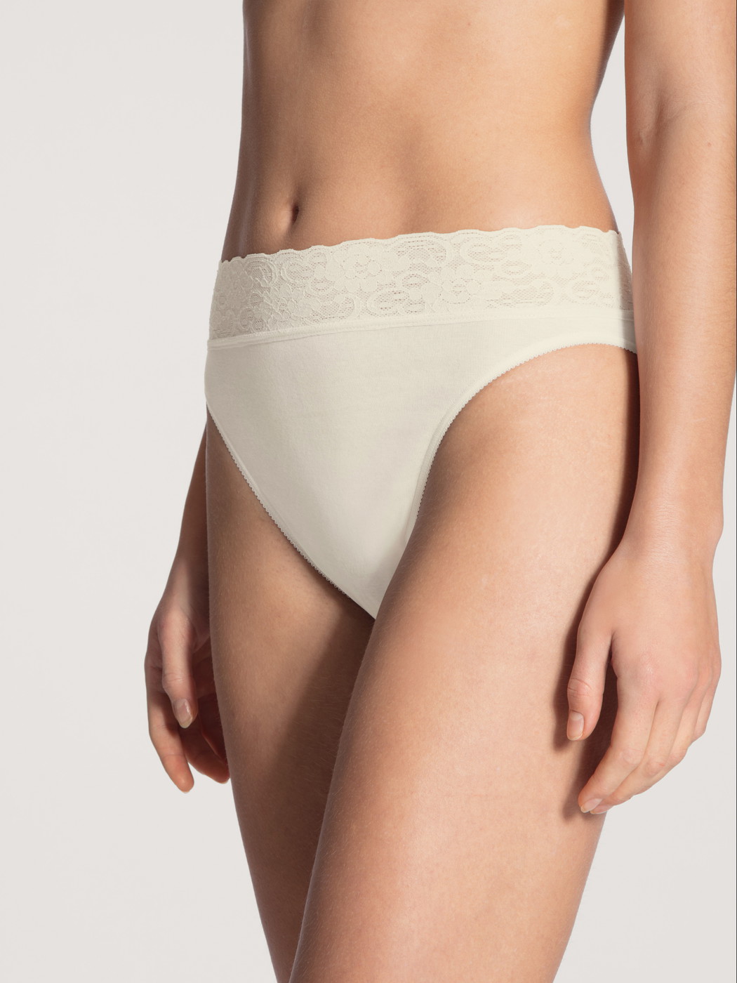 Women model is wearing Brief made of 100% Cotton in Beige, Lace from the Iconics series by CALIDA, Front view
