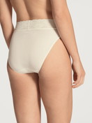 Women model is wearing Brief made of 100% Cotton in Beige, Lace from the Iconics series by CALIDA, Back view