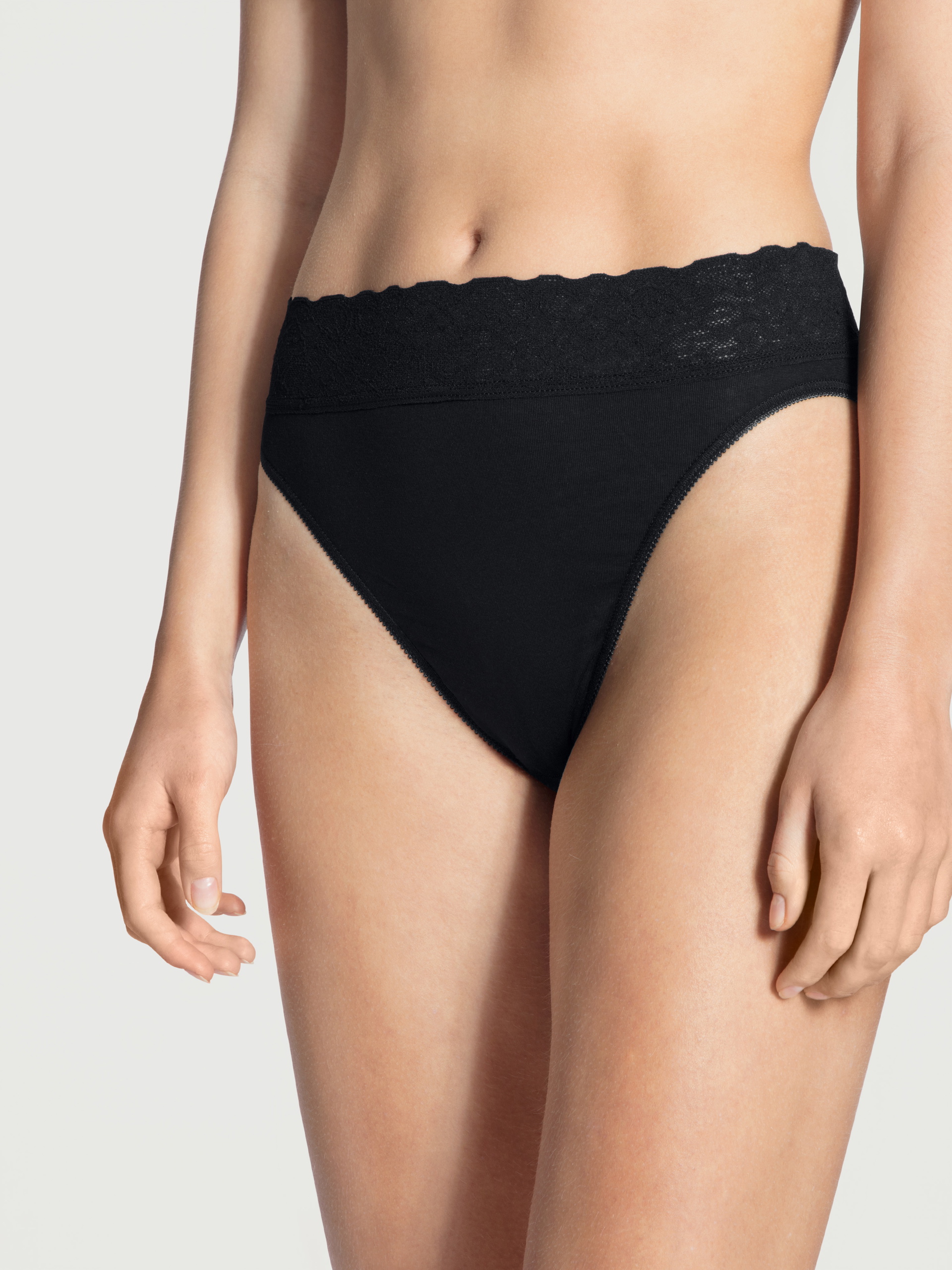 Women model is wearing Brief made of 100% Cotton in Black, Lace from the Iconics series by CALIDA, Front view