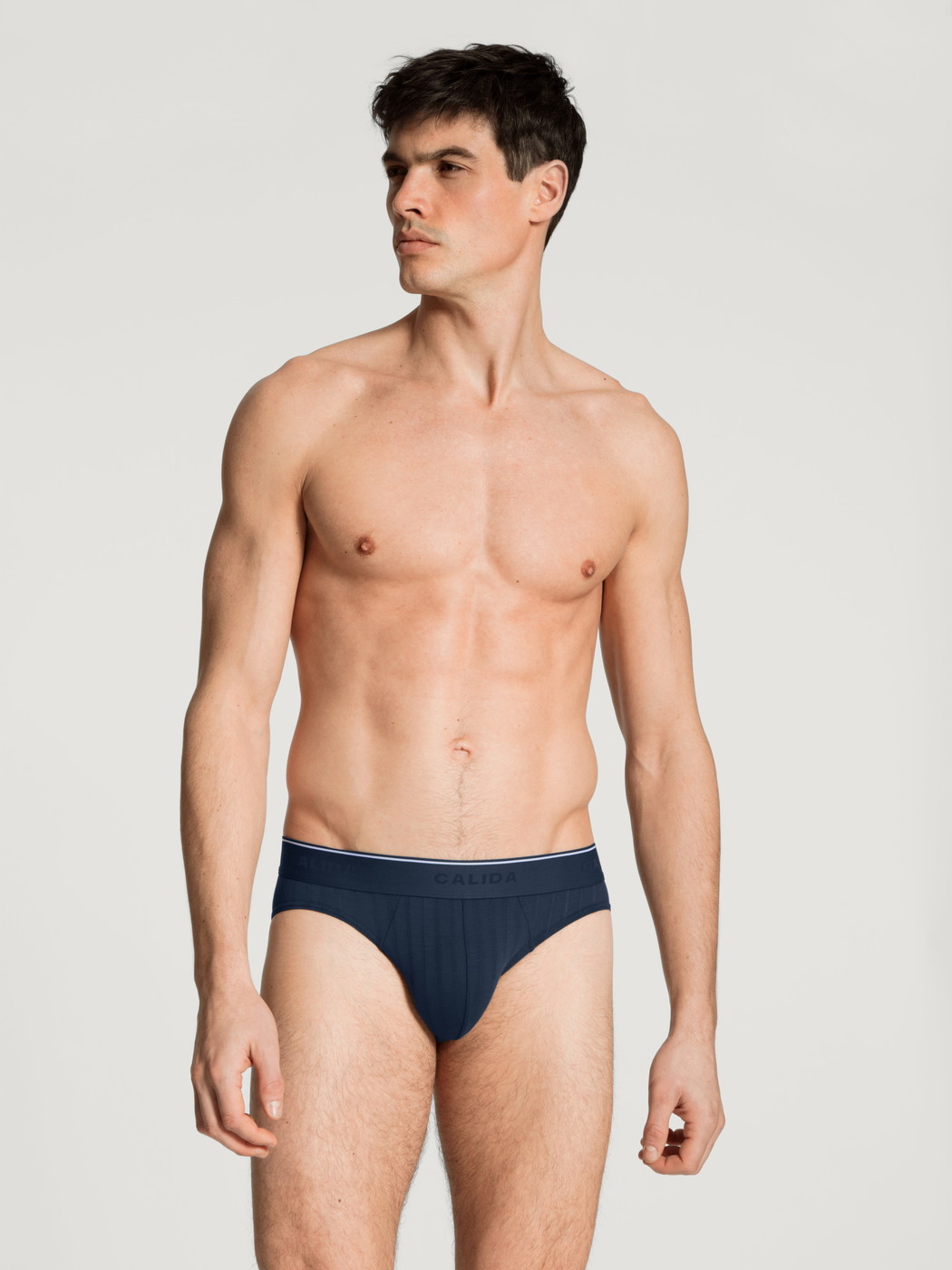Herren-Model trägt Mini-Slip, Elastikbund aus Baumwolle in Blau, Einfarbig aus Serie Pure & Style von CALIDA, Outfit, Vorderansicht