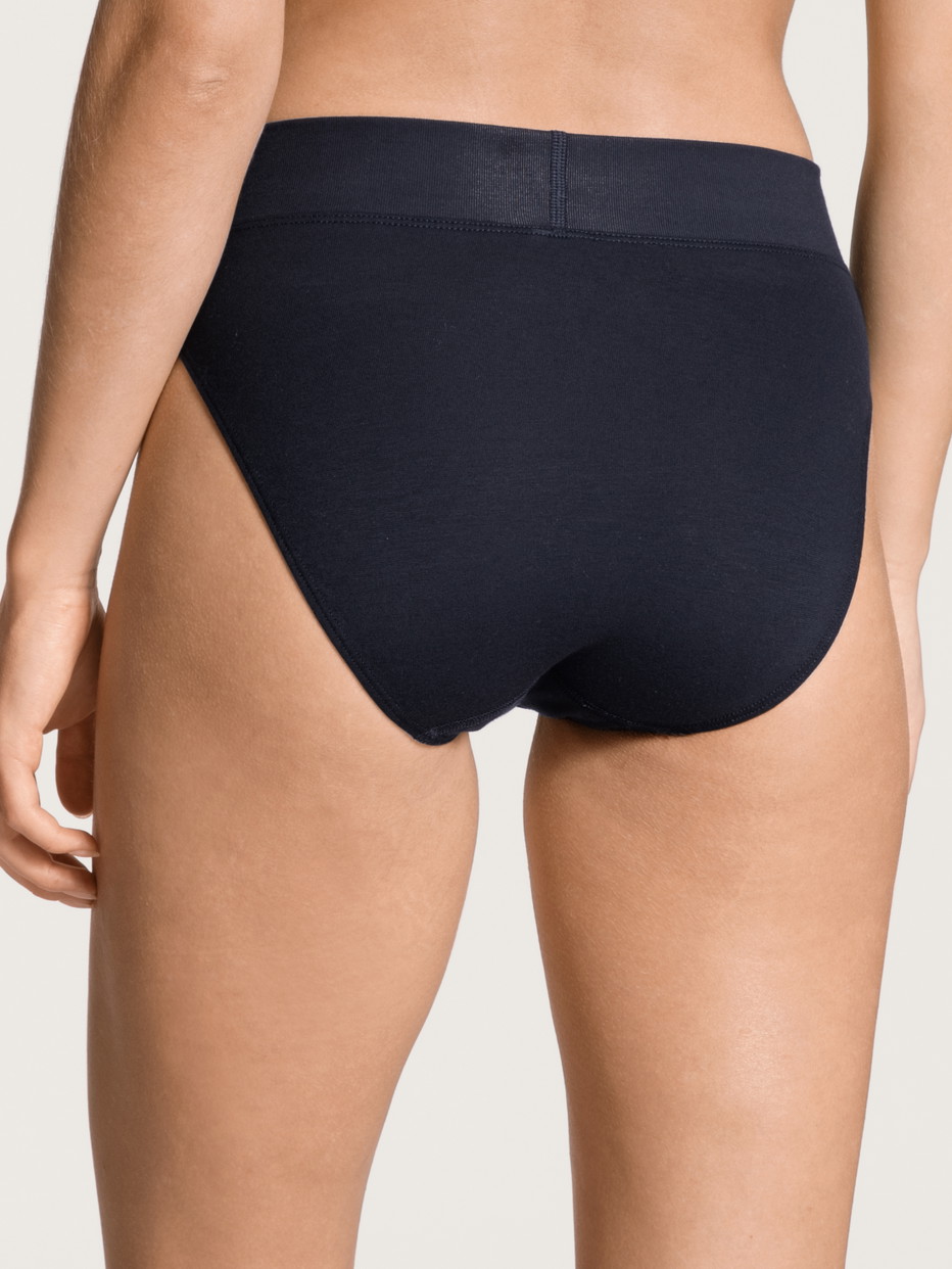 Women model is wearing Brief, high waist made of Cotton in Blue, Unicoloured from the Elastic series by CALIDA, Back view