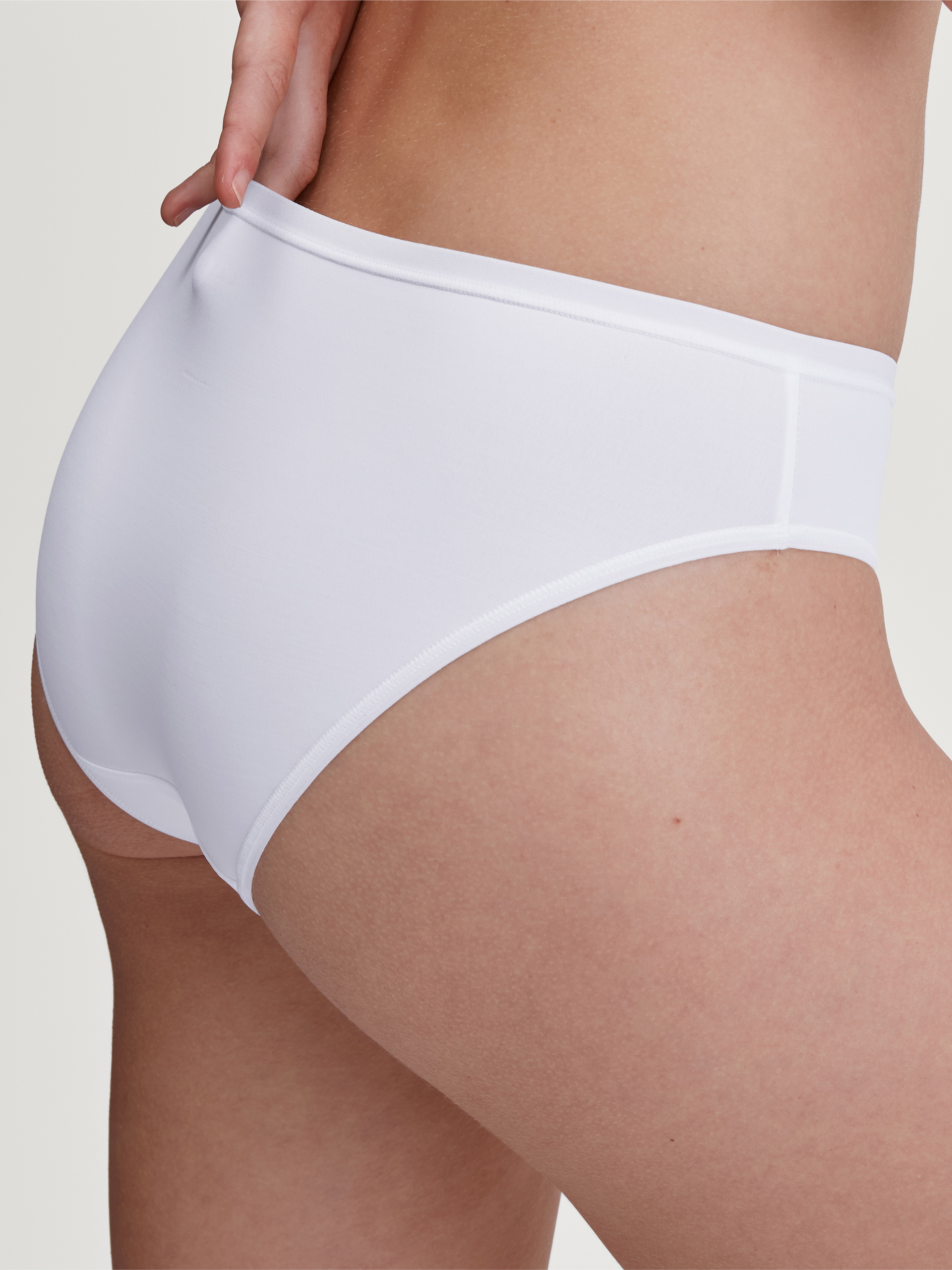 Women model is wearing Brief, regular cut made of Polyamide in White, Unicoloured from the Sleek Skin series by CALIDA, Front view