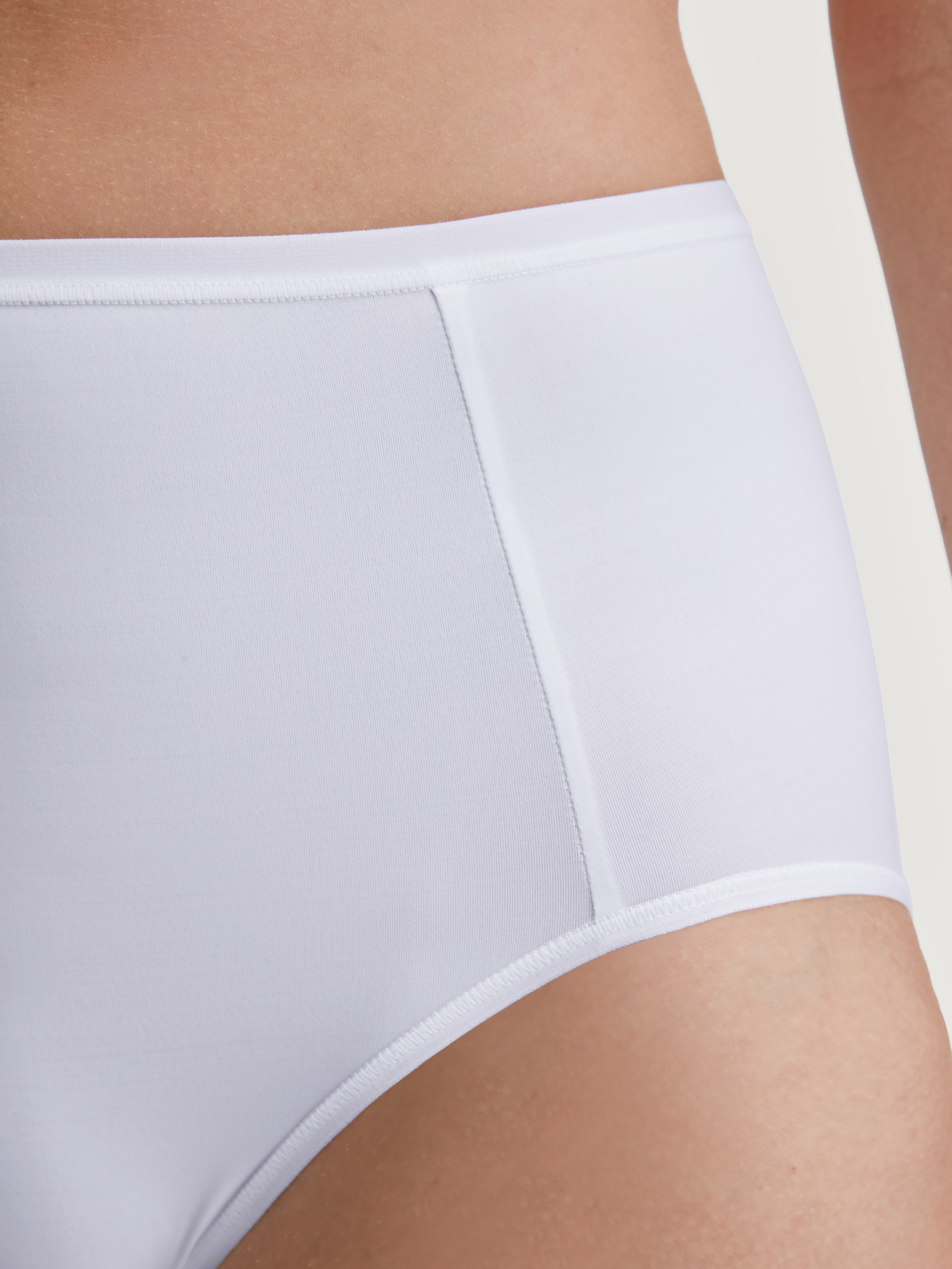 Women model is wearing Brief, high waist made of Polyamide in White, Unicoloured from the Sleek Skin series by CALIDA, Detail