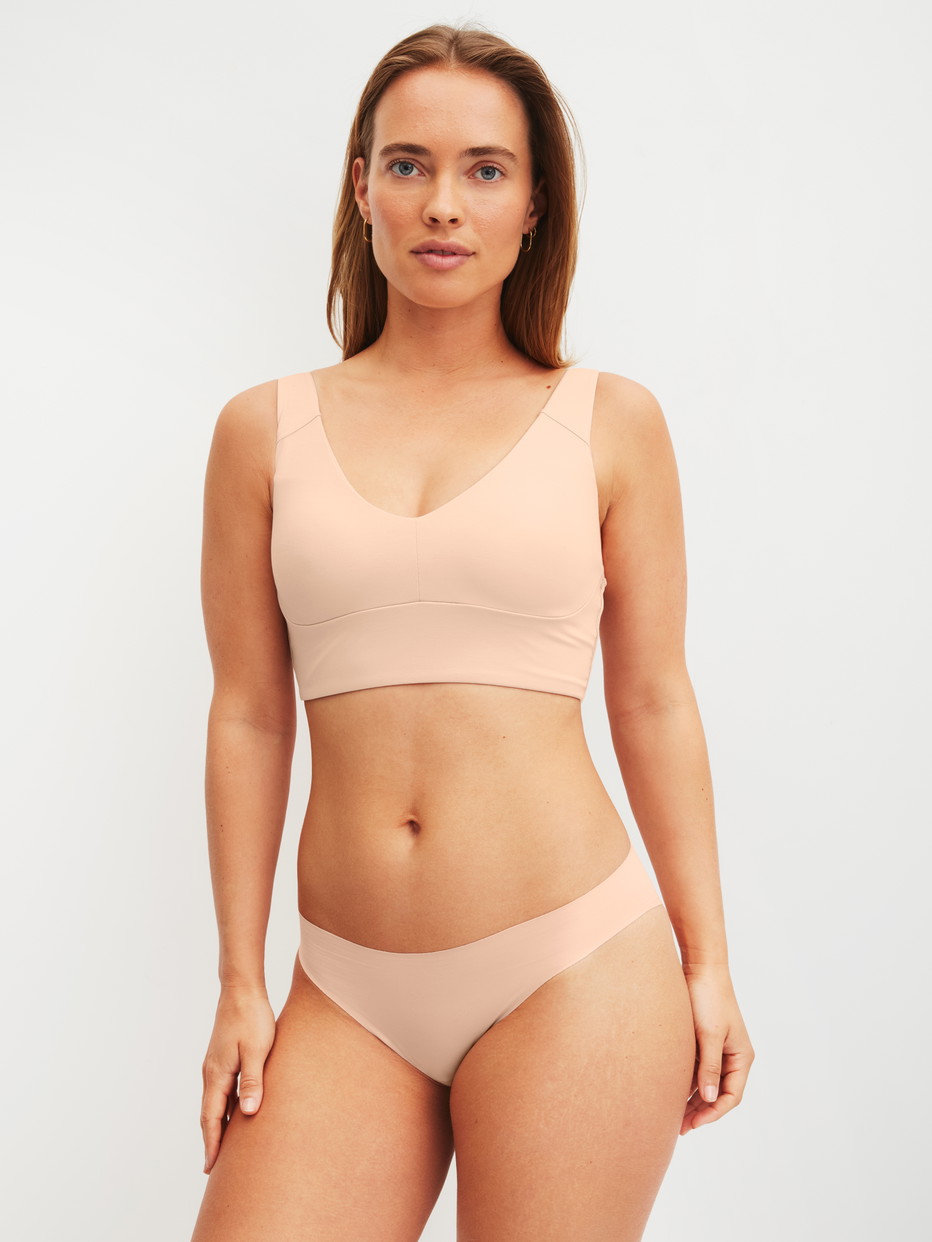 Damen-Model trägt Seamless Brazilian Slip aus Modal in Rosa, Einfarbig aus Serie Natural Skin von CALIDA, Outfit