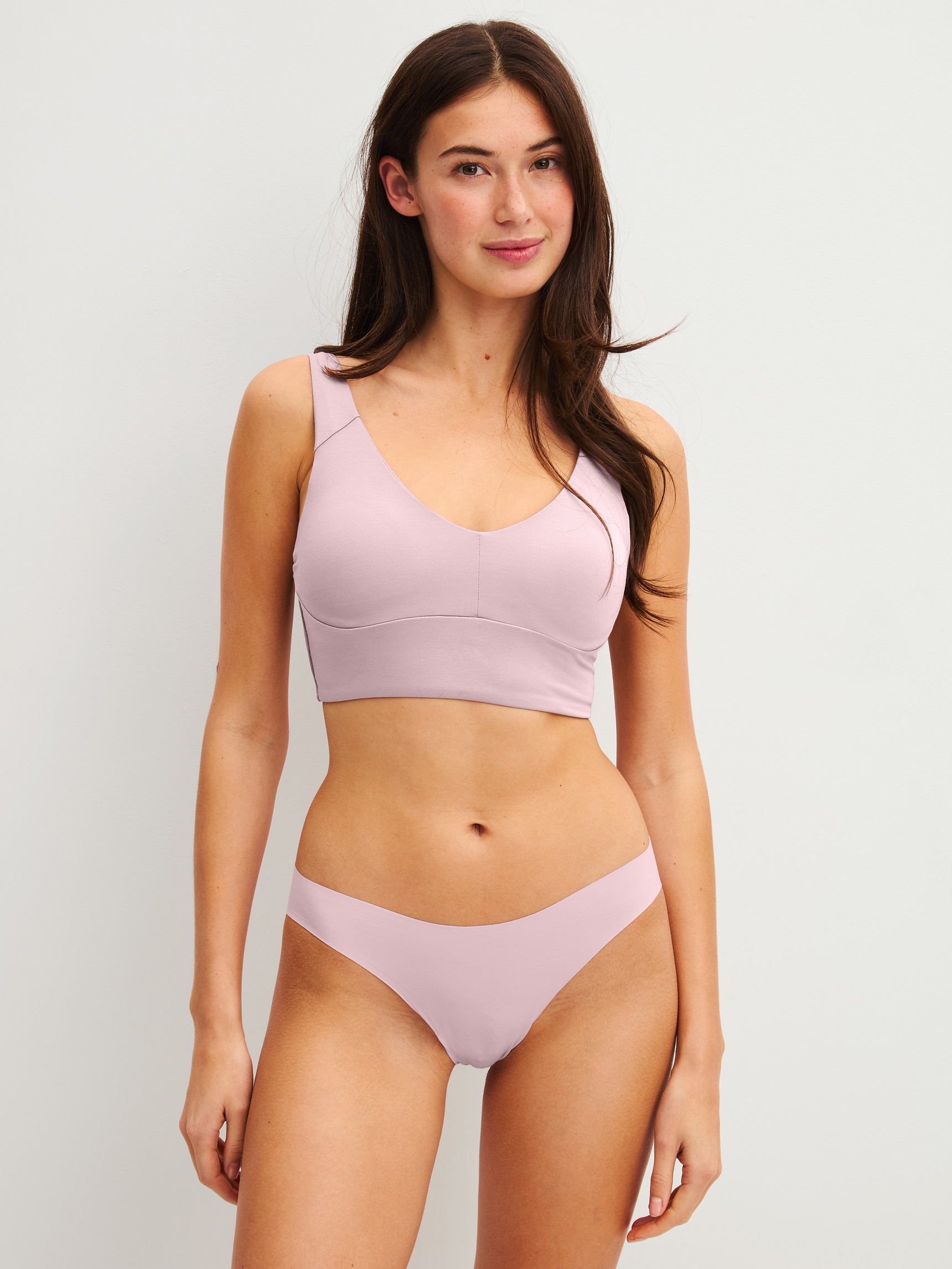 Women model is wearing Seamless Brazilian Brief made of Modal in Purple, Unicoloured from the Natural Skin series by CALIDA, Outfit