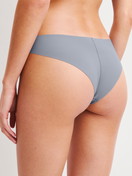 Damen-Model trägt Seamless Brazilian Slip aus Modal in Grau, Einfarbig aus Serie Natural Skin von CALIDA, Rückansicht