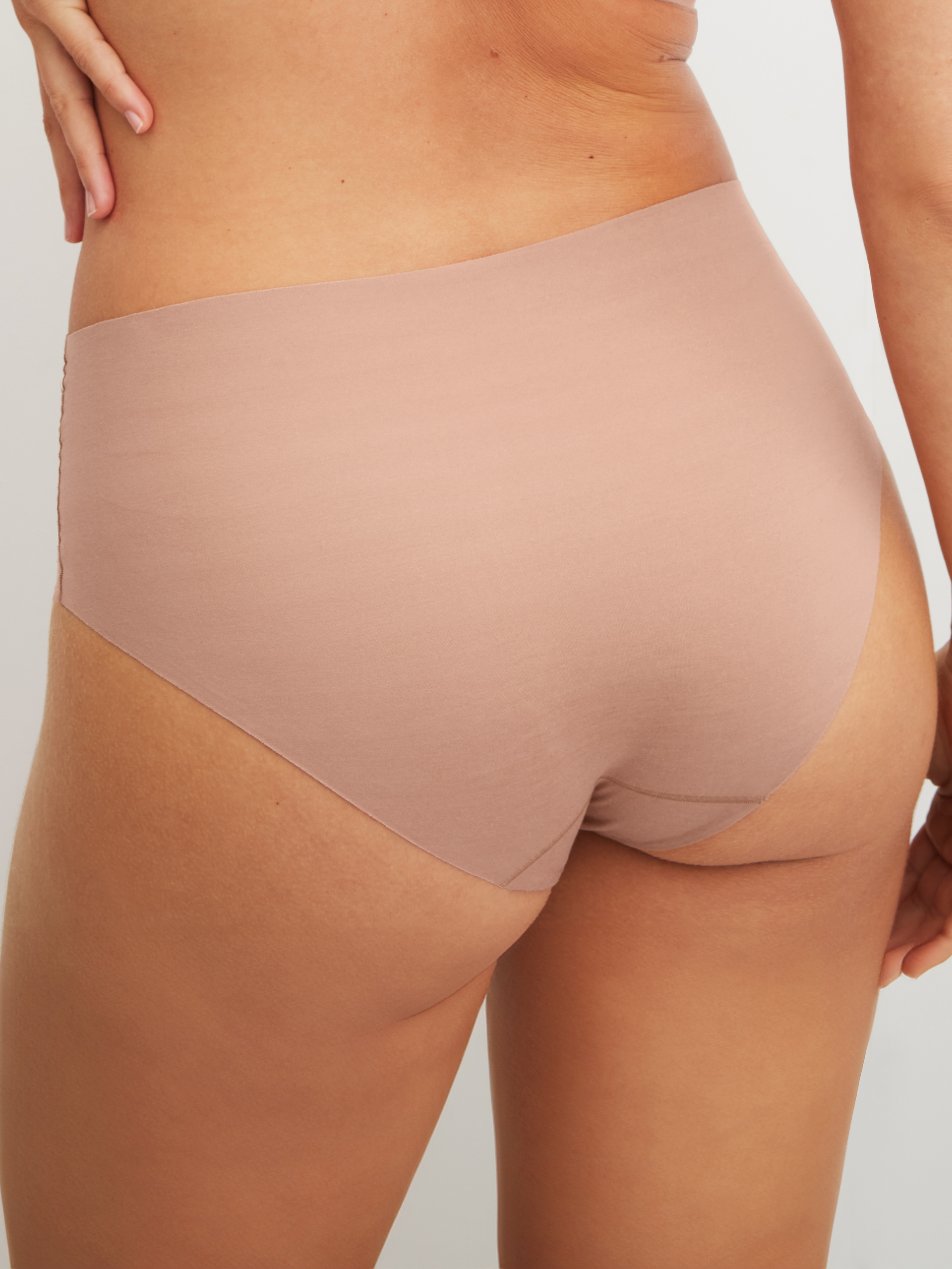 Women model is wearing Brief made of Modal in Brown, Unicoloured from the Natural Skin series by CALIDA, Back view