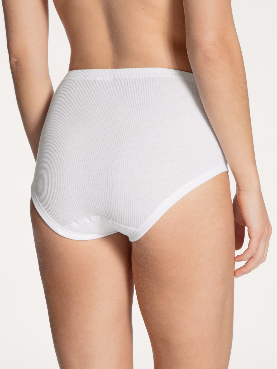 Women model is wearing Midi brief made of 100% Cotton in White, Unicoloured from the Iconics series by CALIDA, Back view