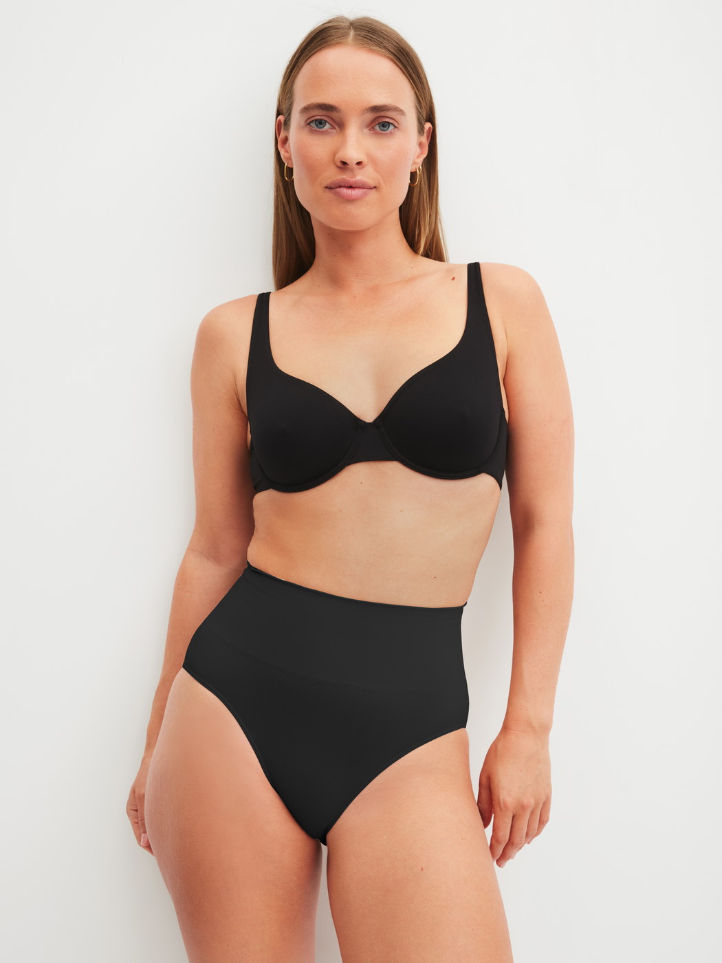 Women model is wearing Shapewear brief made of Polyamide in Black, Unicoloured from the Seamless Shape series by CALIDA, Outfit