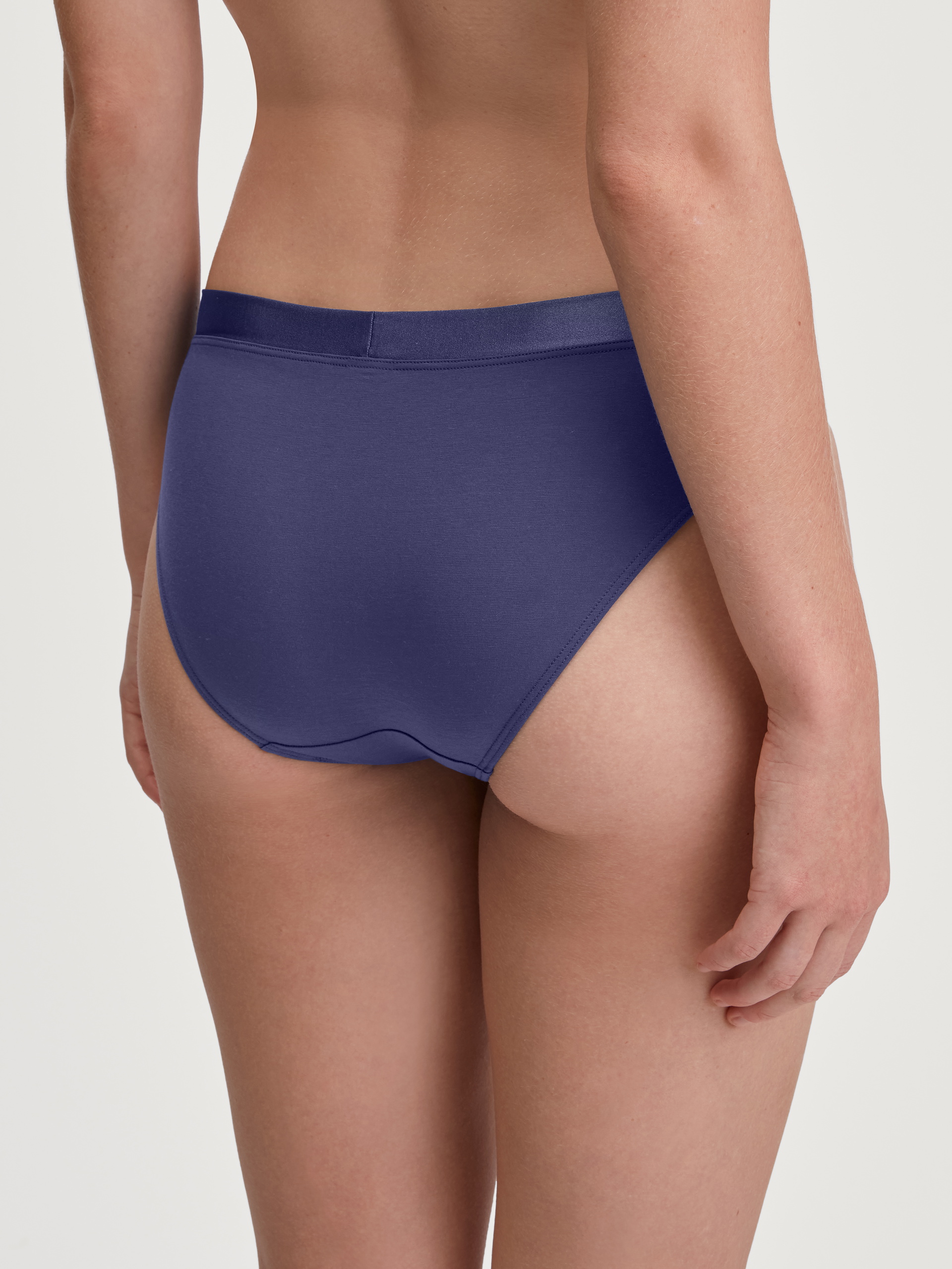 Women model is wearing Brief made of Cotton in Blue, Unicoloured from the Cate series by CALIDA, Back view