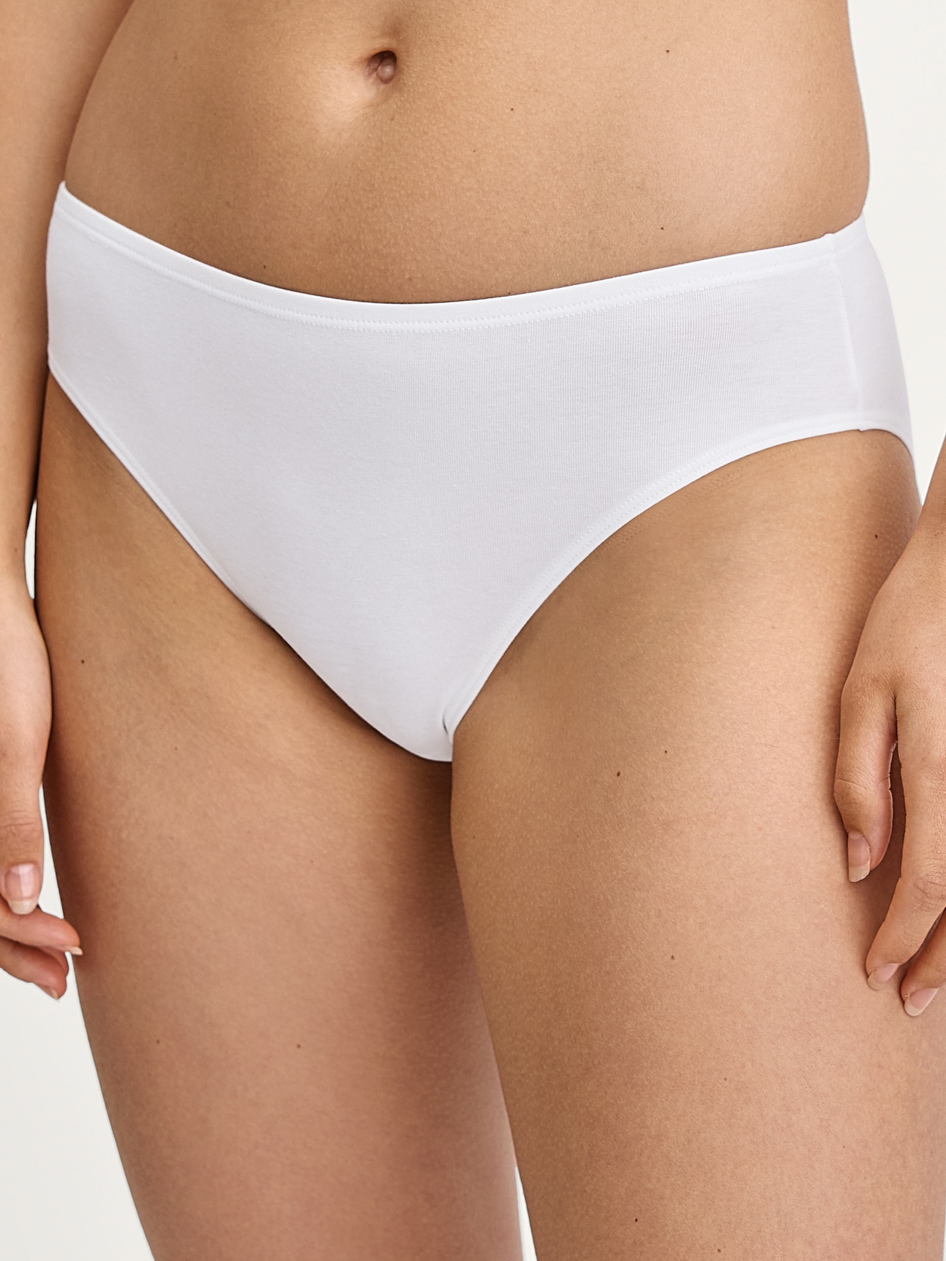 Women model is wearing Brief, regular cut made of Cotton in White, Unicoloured from the Essential Cotton series by CALIDA, Front view
