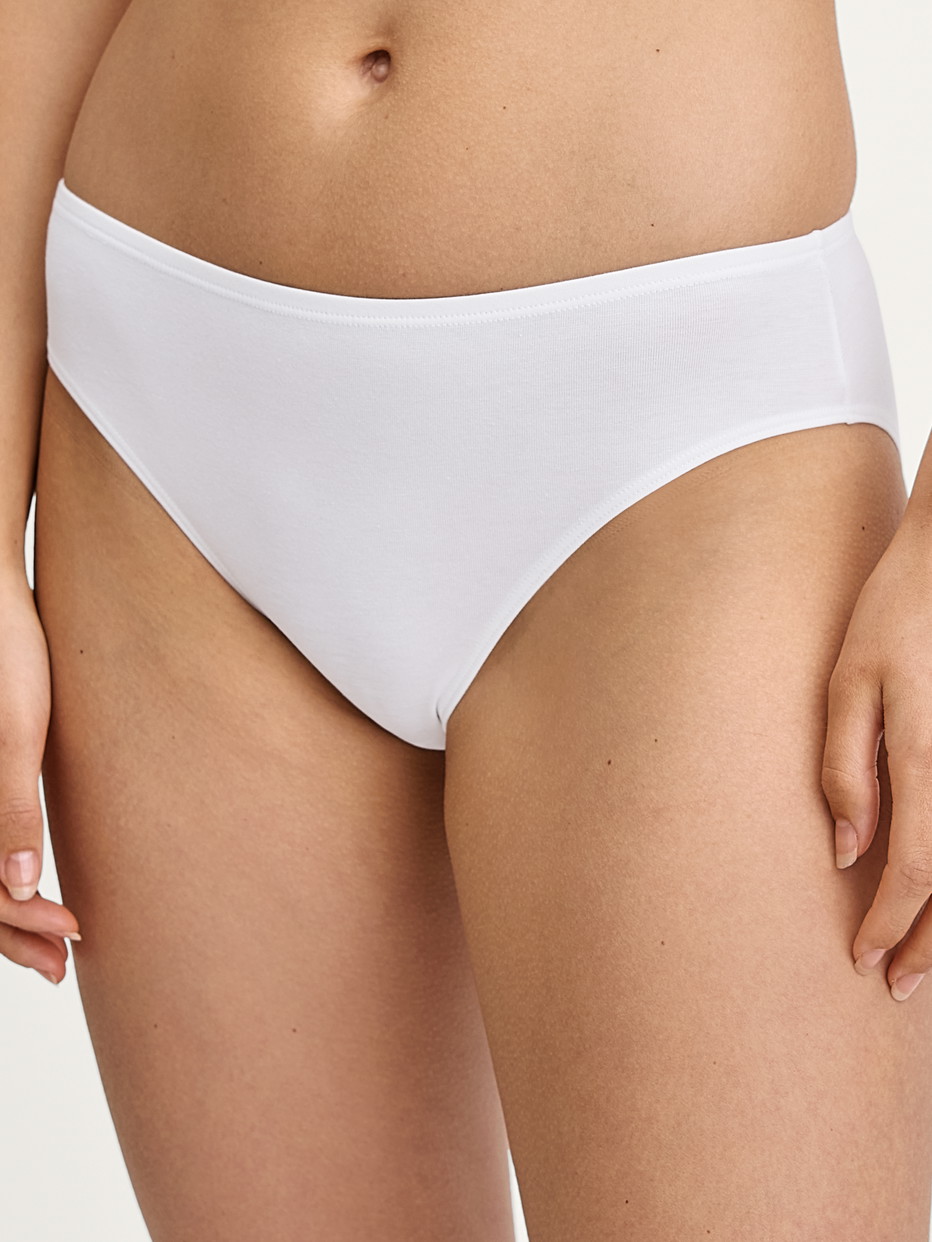 Damen-Model trägt Slip, regular cut aus Baumwolle in Weiß, Einfarbig aus Serie Essential Cotton von CALIDA, Vorderansicht