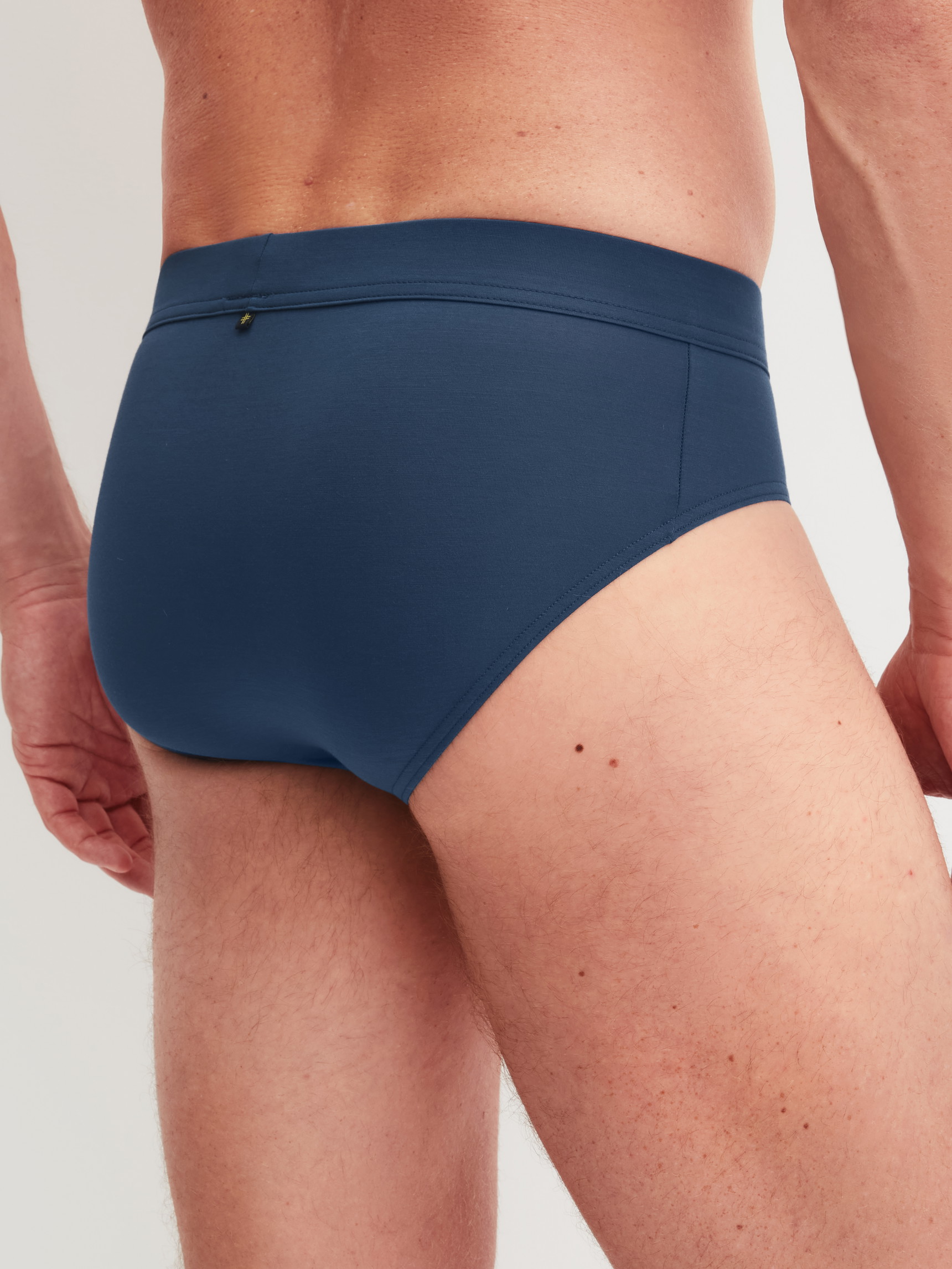 Men model is wearing Slip made of Modal in Blue, Unicoloured from the Balanced Day series by CALIDA, Back view