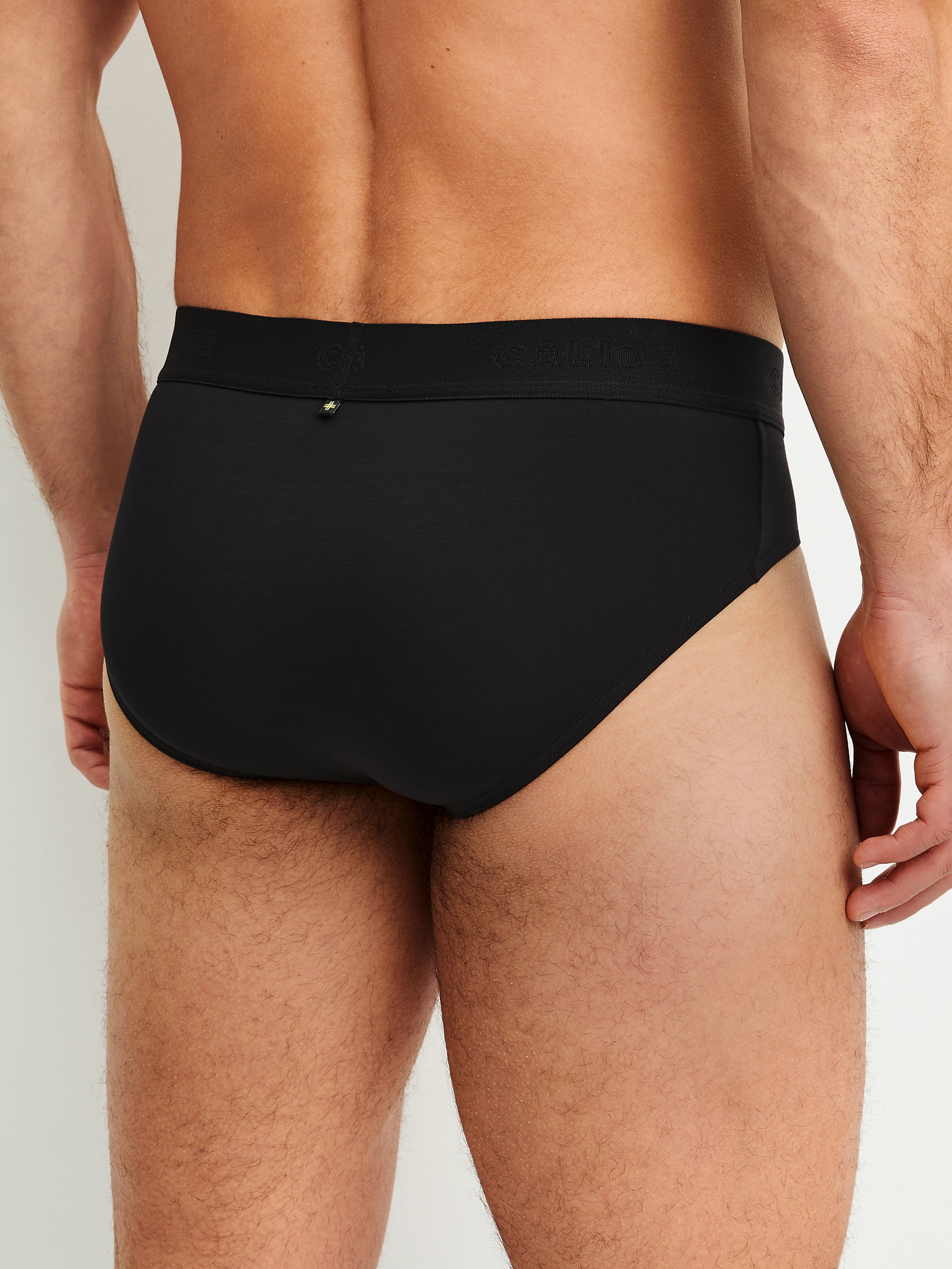Men model is wearing Brief made of Modal in Black, Unicoloured from the Clean Line series by CALIDA, Back view