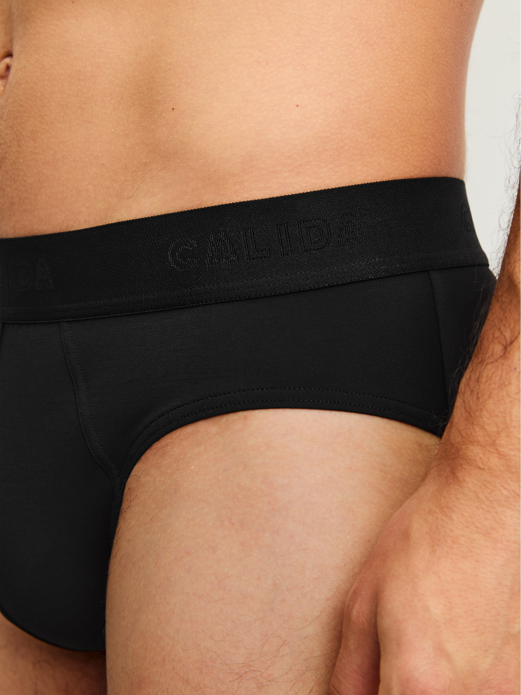 Men model is wearing Brief made of Modal in Black, Unicoloured from the Clean Line series by CALIDA, Detail