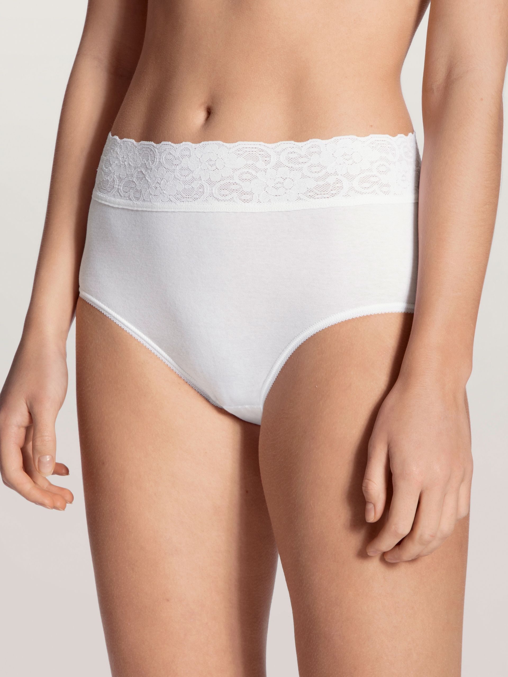 Women model is wearing Midi brief made of 100% Cotton in White, Lace from the Iconics series by CALIDA, Front view