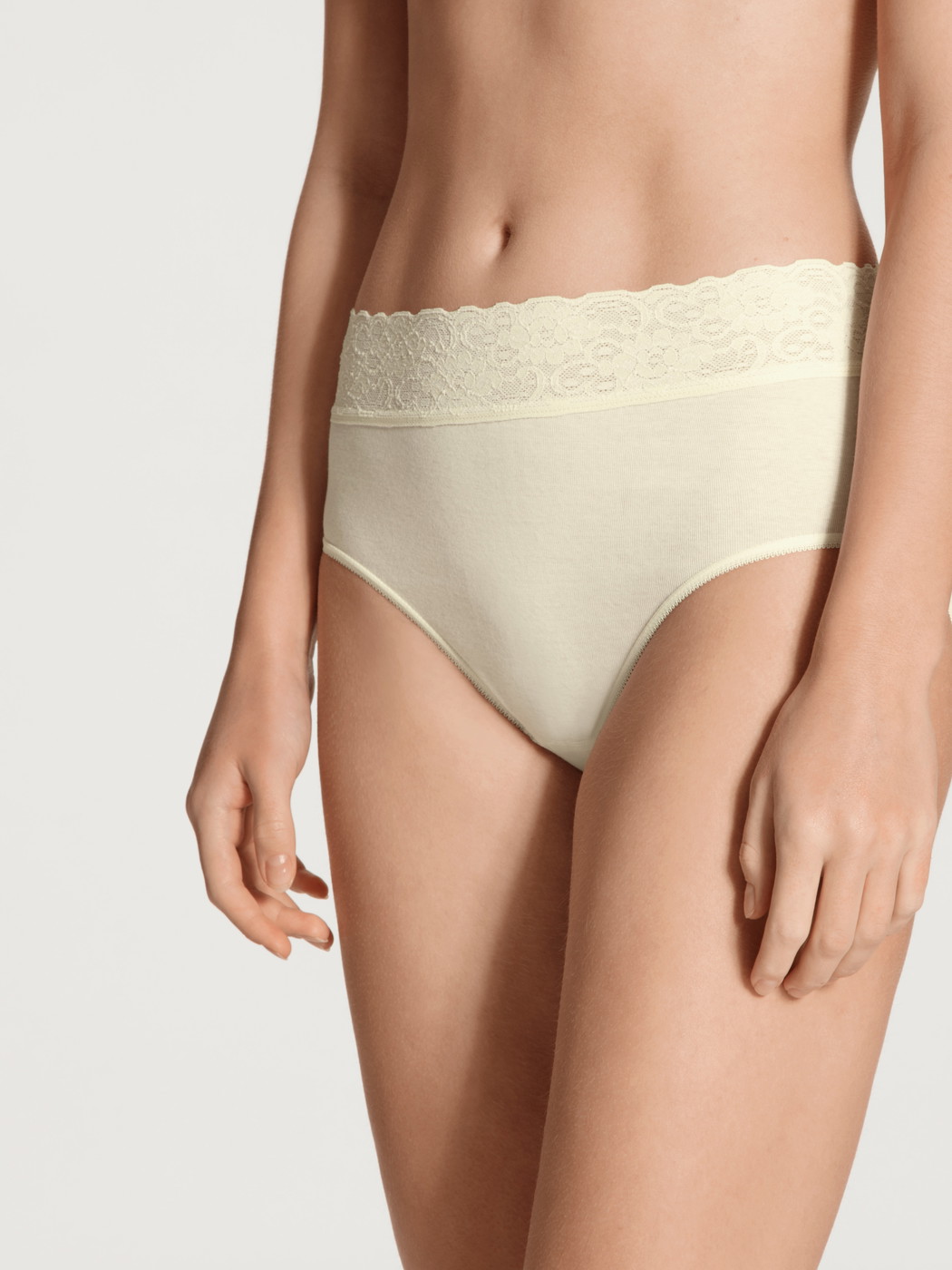 Women model is wearing Midi brief made of 100% Cotton in Beige, Lace from the Iconics series by CALIDA, Front view