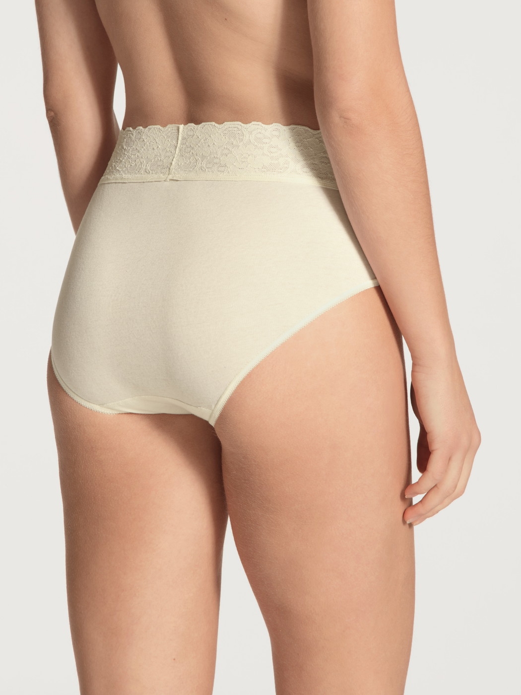 Women model is wearing Midi brief made of 100% Cotton in Beige, Lace from the Iconics series by CALIDA, Back view