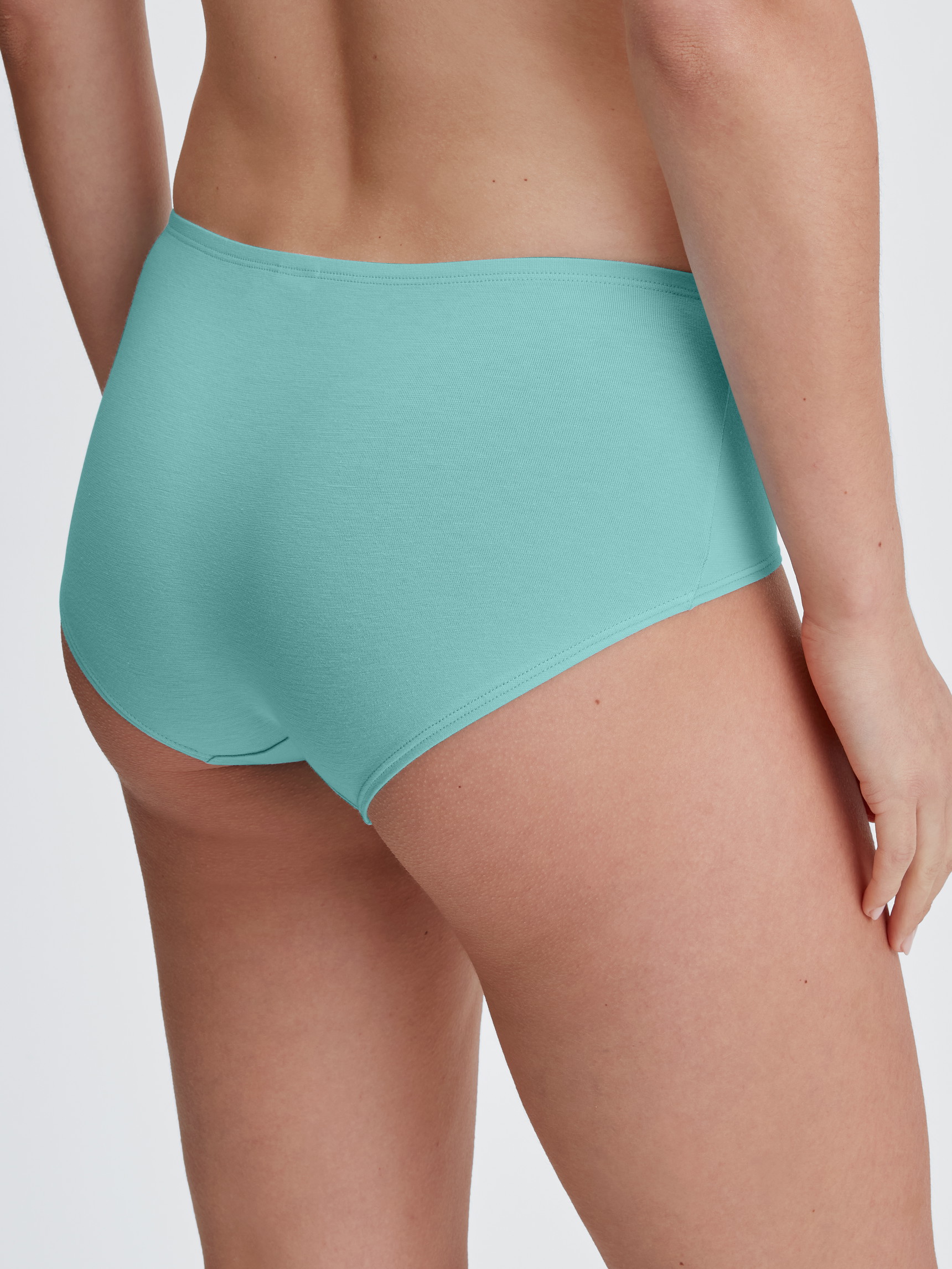 Women model is wearing Panty, low cut made of Cotton in Turquoise, Unicoloured from the Nat. Comfort Xtra series by CALIDA, Back view