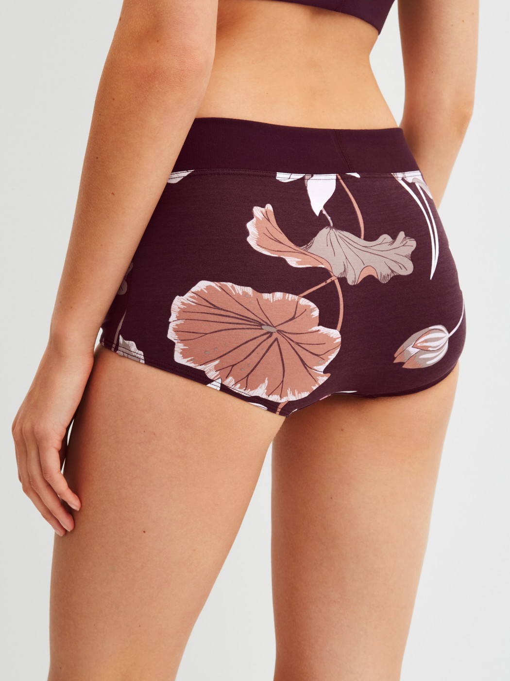 Women model is wearing Shorty regular cut made of Cotton in Red, Floral from the Elastic Trend Spec. series by CALIDA, Back view