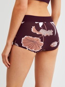 Women model is wearing Shorty regular cut made of Cotton in Red, Floral from the Elastic Trend Spec. series by CALIDA, Back view