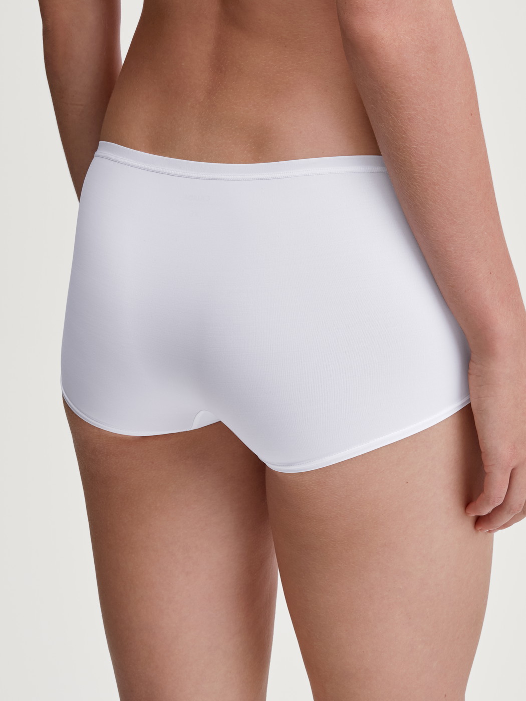 Women model is wearing Shorty regular cut made of Polyamide in White, Unicoloured from the Sleek Skin series by CALIDA, Back view