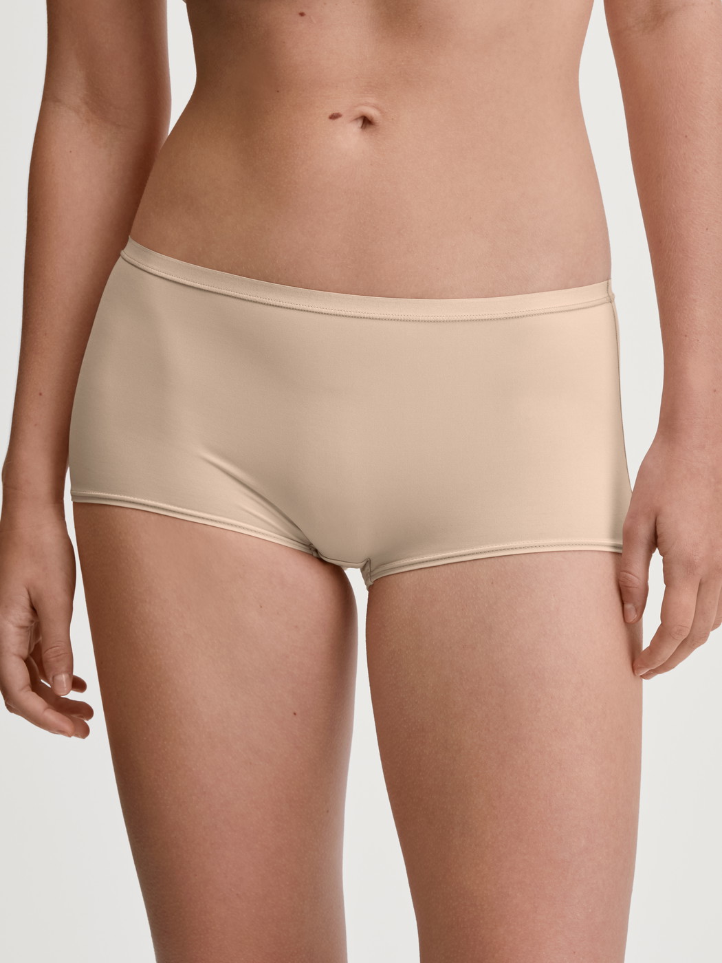 Women model is wearing Shorty regular cut made of Polyamide in Beige, Unicoloured from the Sleek Skin series by CALIDA, Front view
