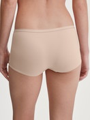 Women model is wearing Shorty regular cut made of Polyamide in Beige, Unicoloured from the Sleek Skin series by CALIDA, Back view