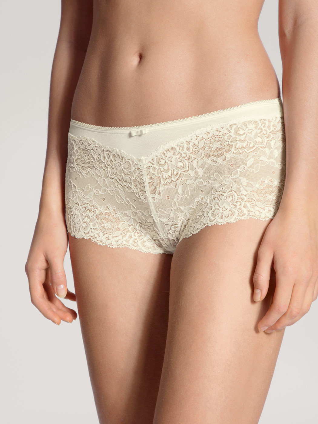 Women model is wearing Shorty regular cut made of Viscose in White, Lace from the Sensual Secrets series by CALIDA, Front view