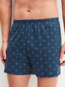 Men model is wearing Boxer shorts made of Cotton in Blue, Patterned from the Prints series by CALIDA, Front view