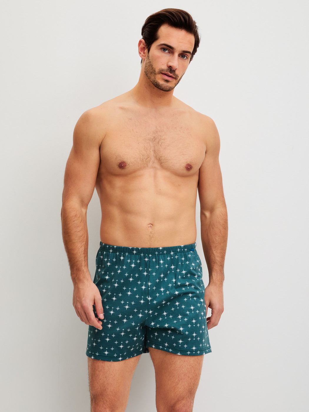 Men model is wearing Boxer shorts made of 100% Cotton in Turquoise, Patterned from the Prints series by CALIDA, Outfit