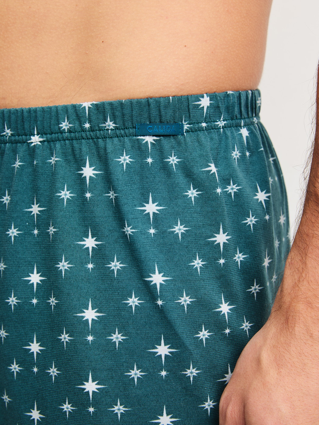 Men model is wearing Boxer shorts made of 100% Cotton in Turquoise, Patterned from the Prints series by CALIDA, Detail
